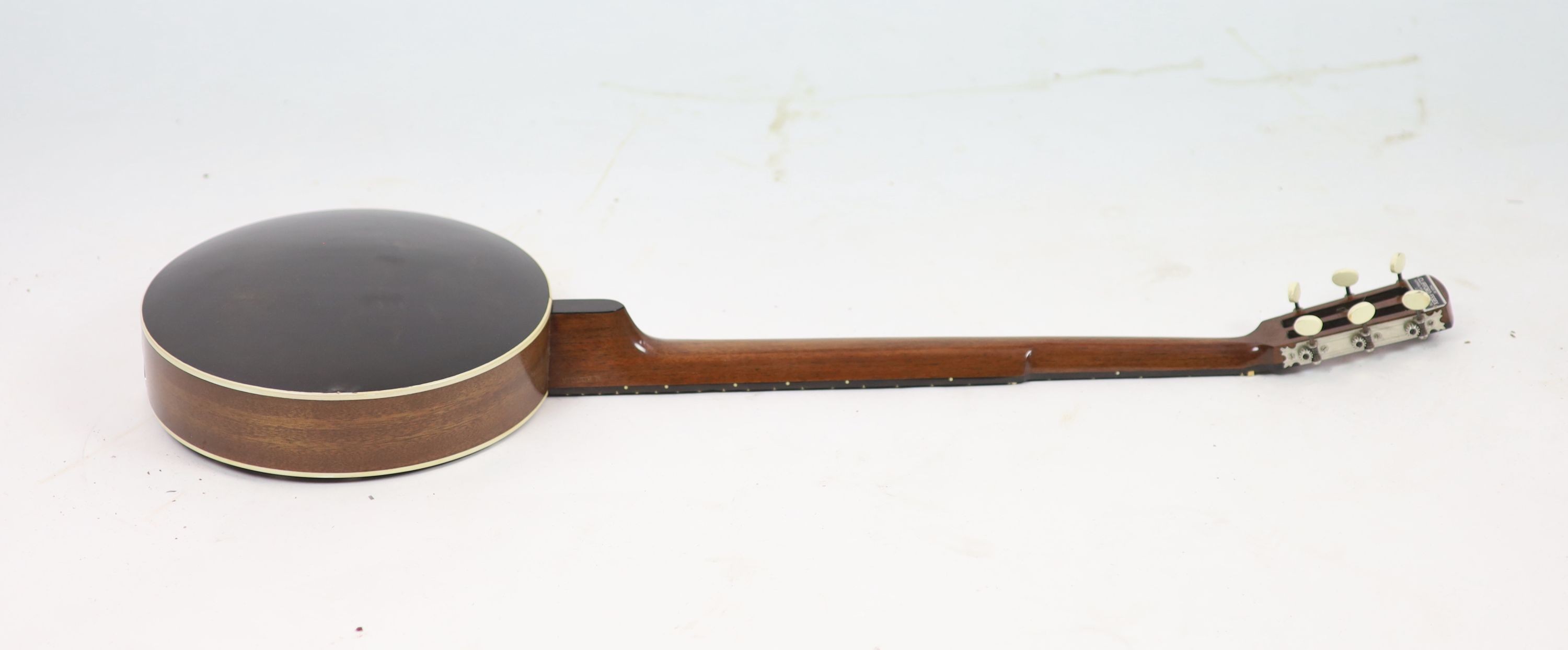 A Clifford Essex ebony mounted banjo, length 94cm, with distressed leather case
